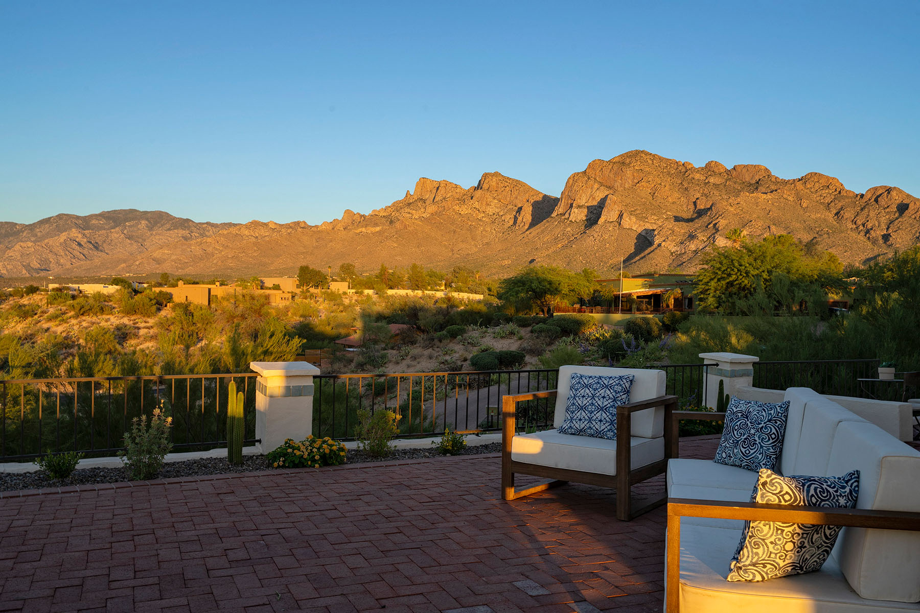 Private outdoor living space featuring comfortable patio seating, desert landscaping, and panoramic Catalina Mountain views in a luxury Tucson home designed for indoor outdoor living and entertaining