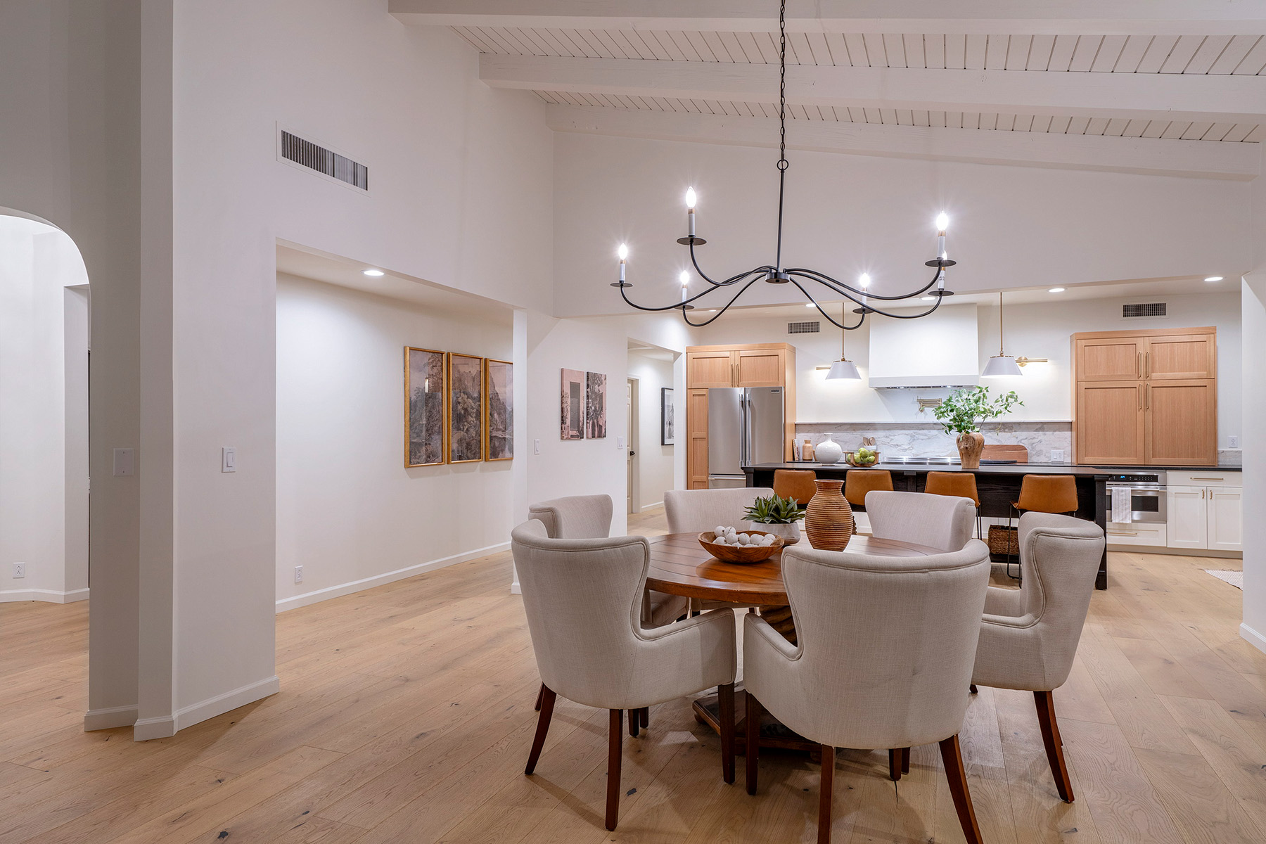 Open concept dining and kitchen renovation featuring white oak cabinetry, vaulted ceilings, natural materials, and thoughtful design