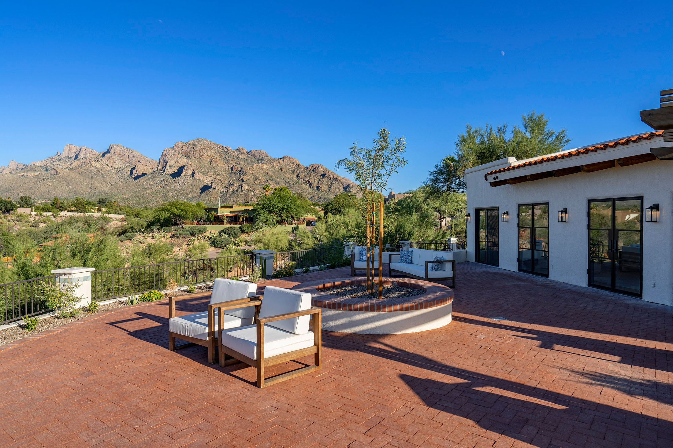 Thoughtfully renovated outdoor entertaining space featuring Catalina Mountain views, custom seating, and timeless Arizona architecture