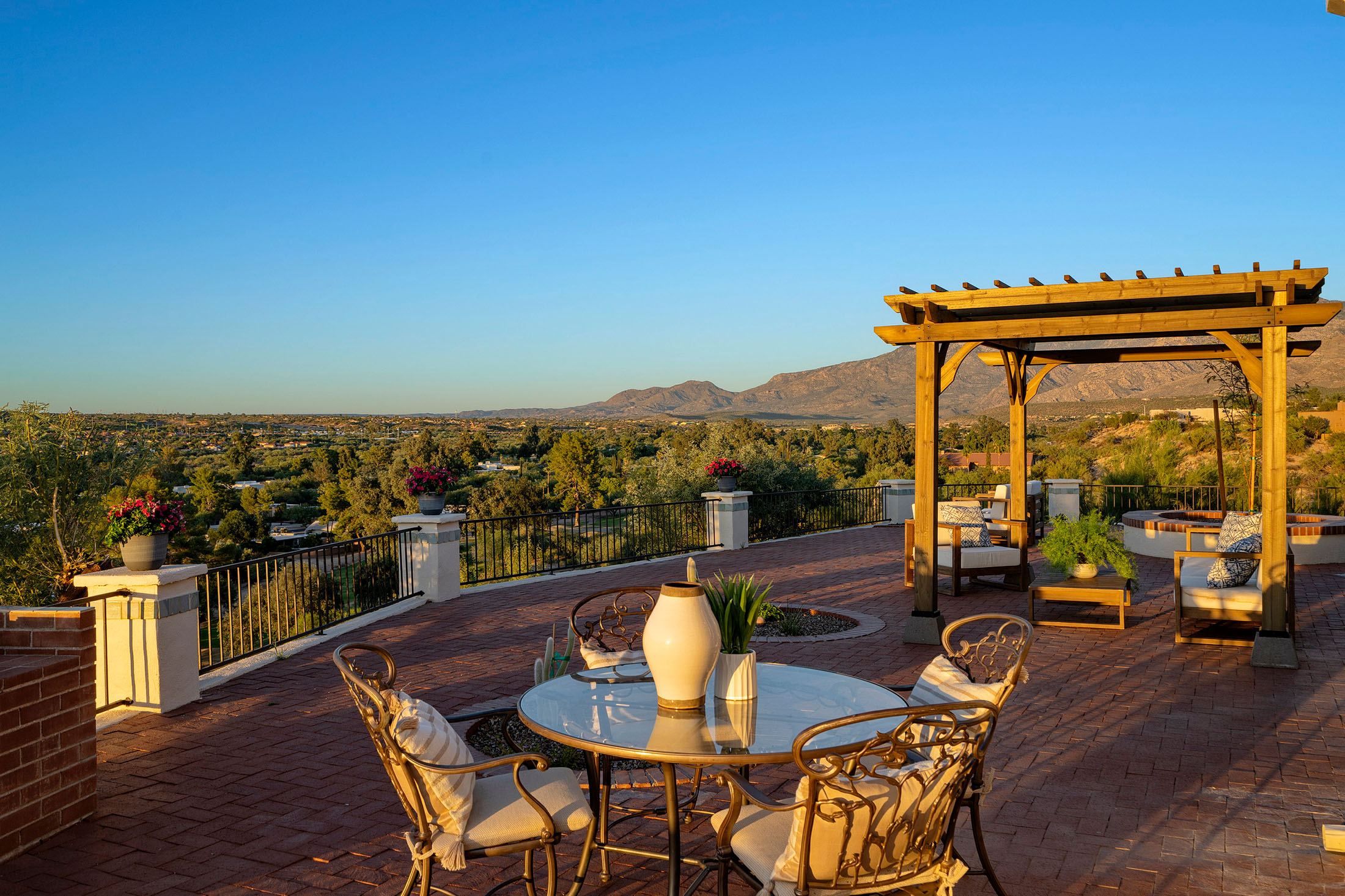 Outdoor dining area designed for entertaining, featuring panoramic Catalina Mountain views, custom hardscaping, and Arizona-inspired outdoor living spaces